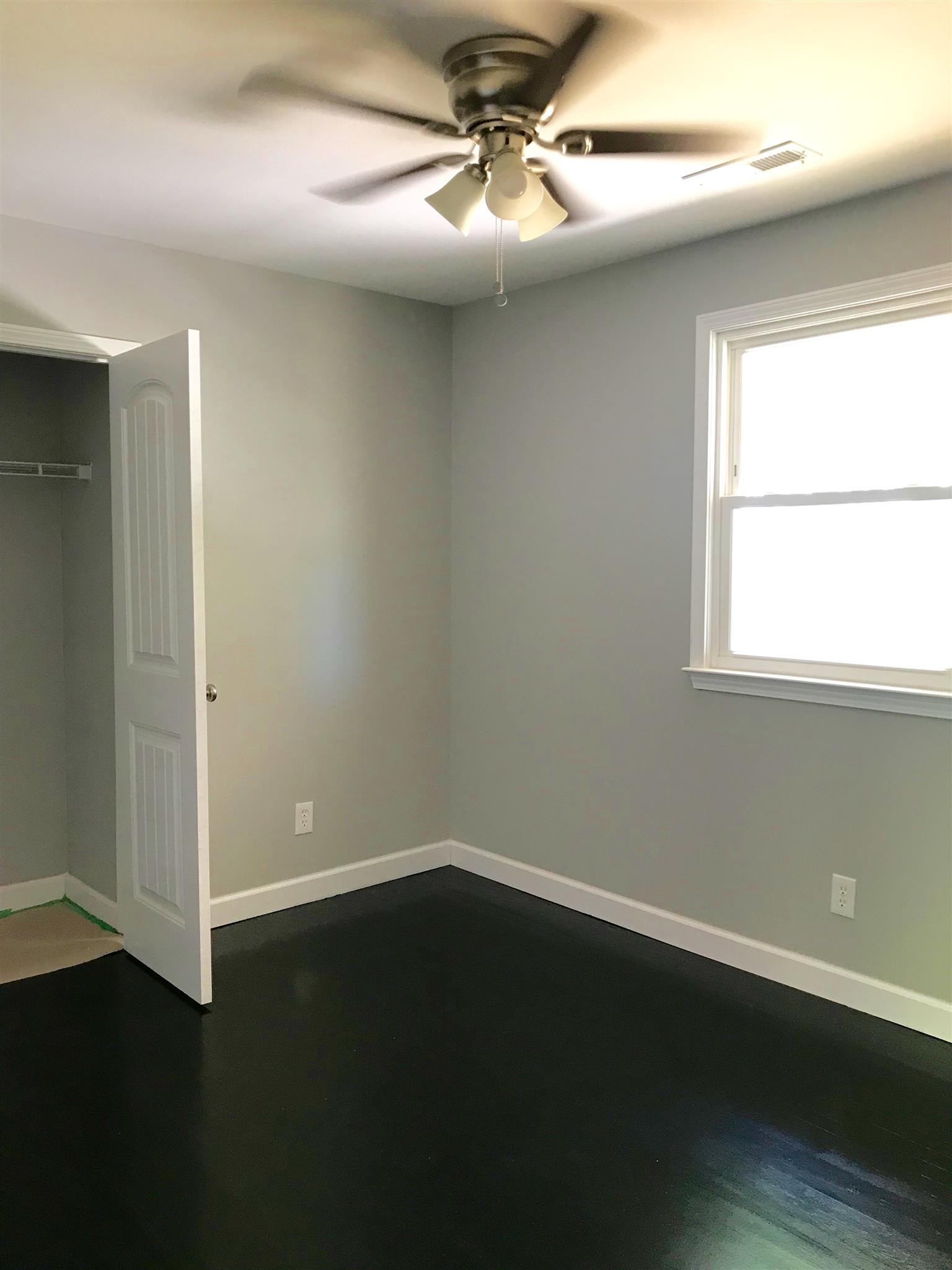 1047 Salem Ridge Road Clarksville, TN 37040 - Photo 16 of 17 an empty room with wooden floor and windows