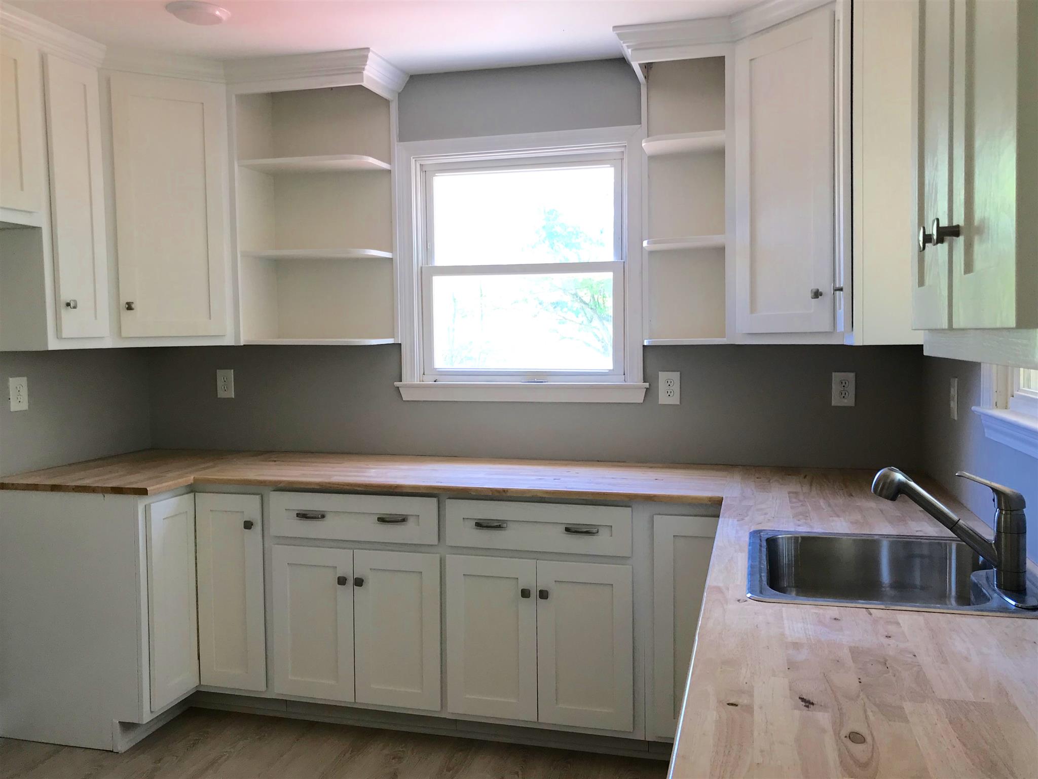 1047 Salem Ridge Road Clarksville, TN 37040 - Photo 9 of 17 a kitchen with granite countertop white cabinets and sink