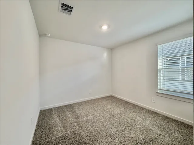 an empty room with a empty space and windows