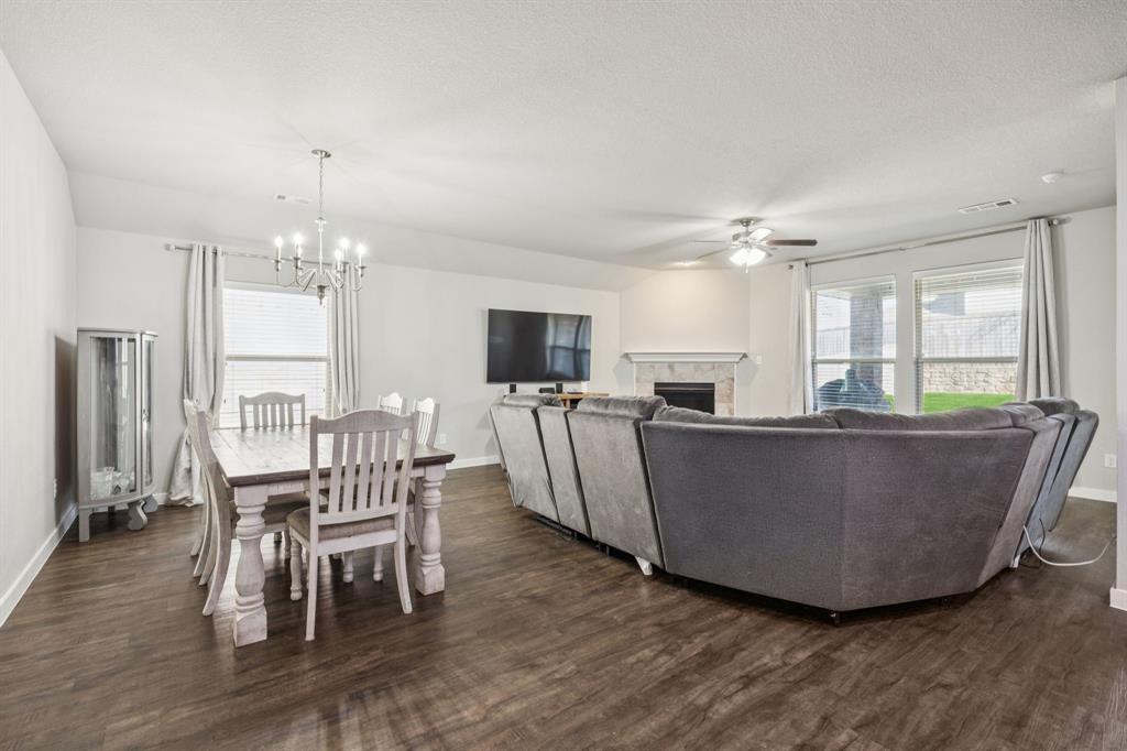 5112 Cathy Drive Forney, TX 75126 - Photo 11 of 32 a living room with furniture a flat screen tv and kitchen view