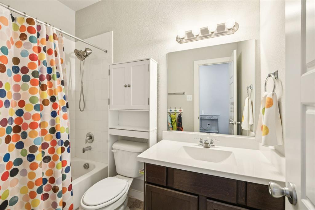 5112 Cathy Drive Forney, TX 75126 - Photo 14 of 32 a bathroom with a sink toilet a mirror and shower