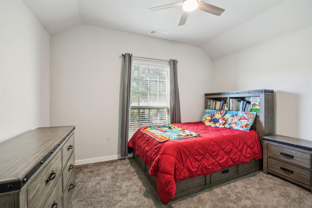 5112 Cathy Drive Forney, TX 75126 - Photo 15 of 32 a bedroom with a bed and a dresser