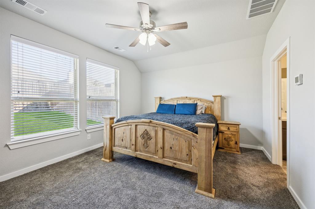 5112 Cathy Drive Forney, TX 75126 - Photo 17 of 32 a view of a bedroom with furniture window and a ceiling fan
