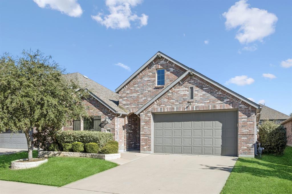 5112 Cathy Drive Forney, TX 75126 - Photo 2 of 32 a front view of a house with a garden and trees