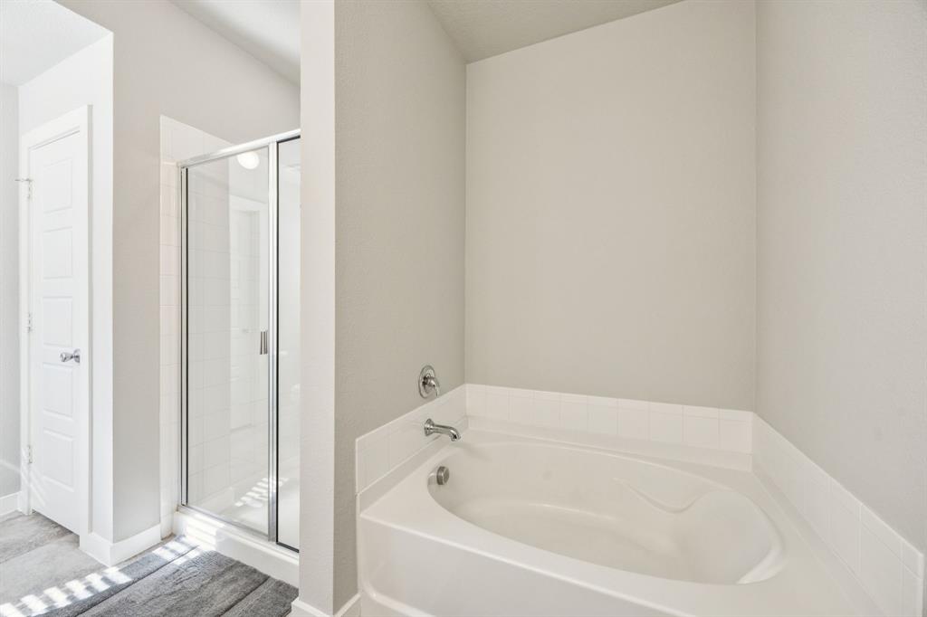 5112 Cathy Drive Forney, TX 75126 - Photo 20 of 32 a white bath tub sitting in a bathroom