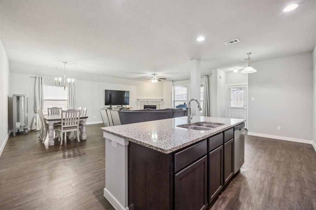 5112 Cathy Drive Forney, TX 75126 - Photo 32 of 32 a kitchen with a stove and chairs
