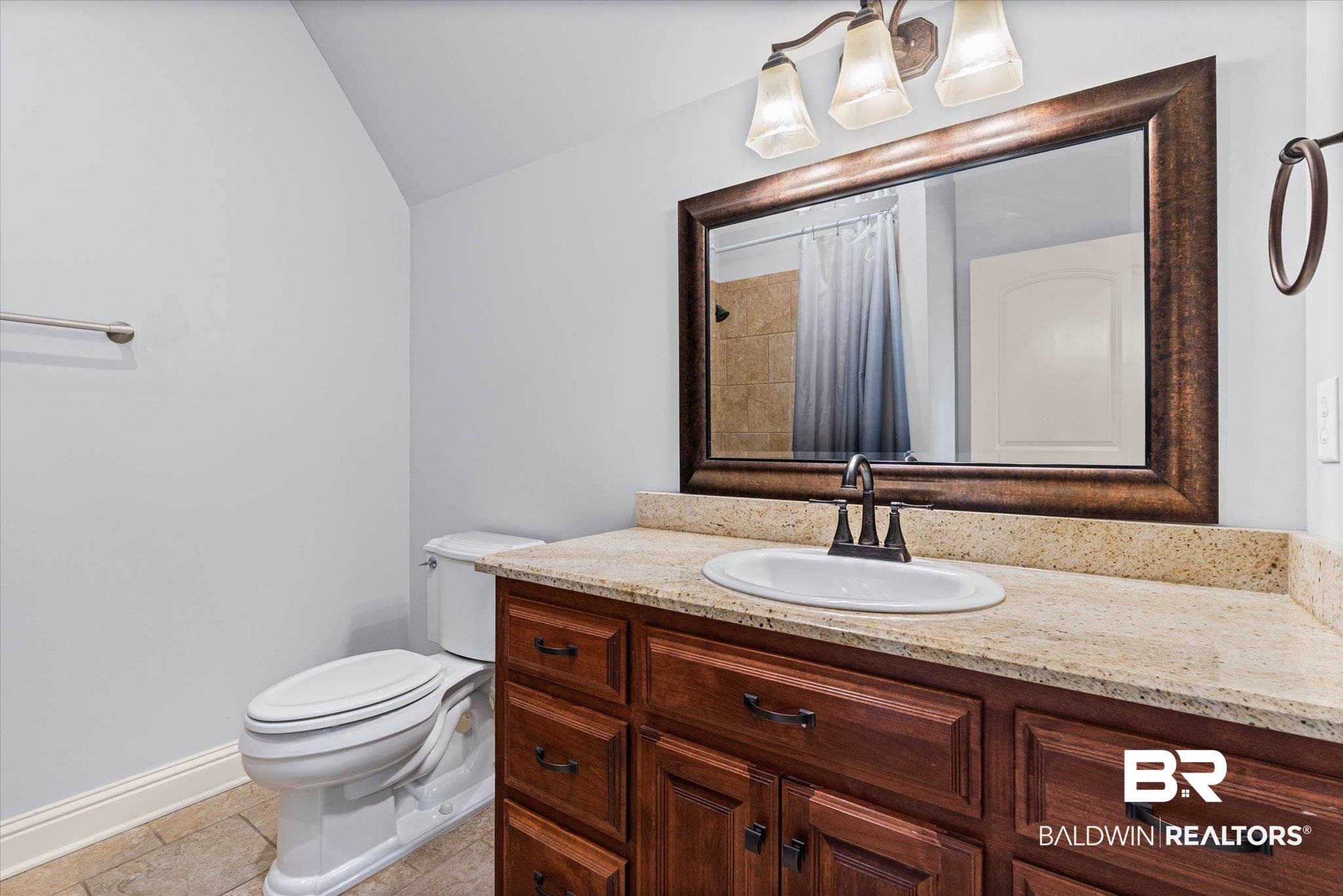 7676 Rockstone Lane Mobile, AL 36695 - Photo 29 of 47 Full bathroom with vanity, lofted ceiling, a shower with shower curtain, and light tile patterned flooring