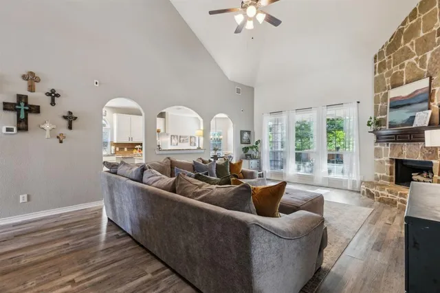 a living room with furniture a fireplace and a chandelier