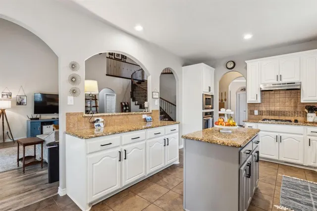 a kitchen with cabinets a sink and appliances