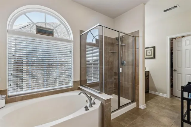 a bathroom with a bathtub and a shower