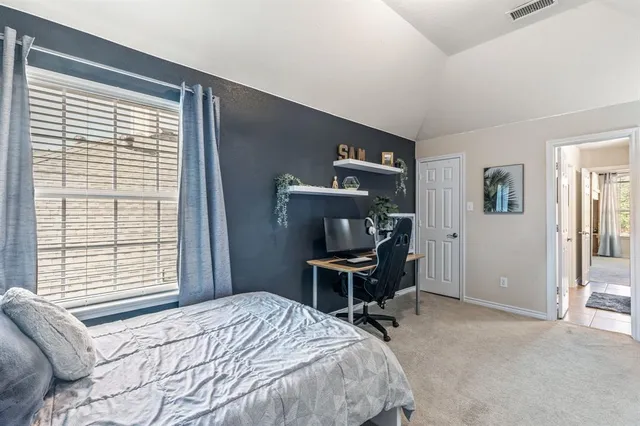 a bedroom with a bed and a window