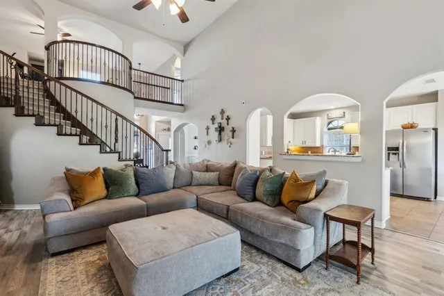 a living room with furniture fireplace and wooden floor