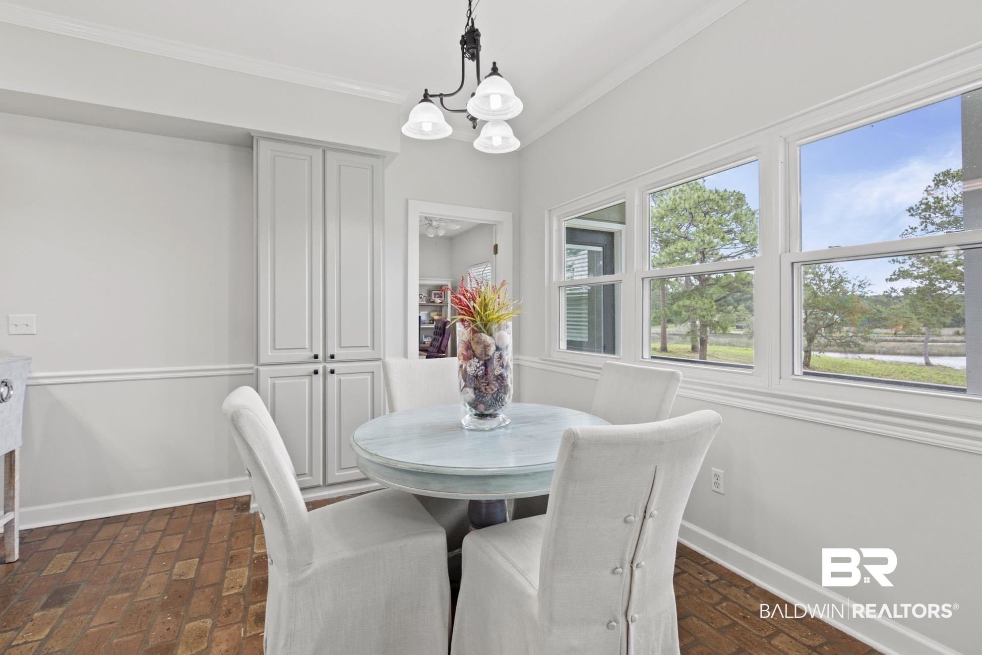 12171 Marguerite Drive Coden, AL 36523 - Photo 10 of 44 Dining area featuring brick-patterned flooring, built-in cabinetry, and multiple windows