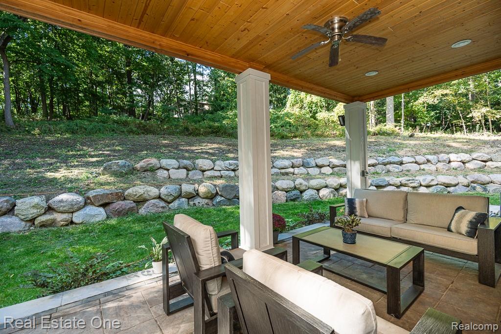 201 Beechview Drive Rochester, MI 48306 - Photo 42 of 49 Covered patio with a wood-finish ceiling, ceiling fan, recessed lighting, and a stone retaining wall