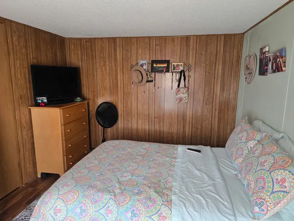 a bedroom with a bed and a television in it