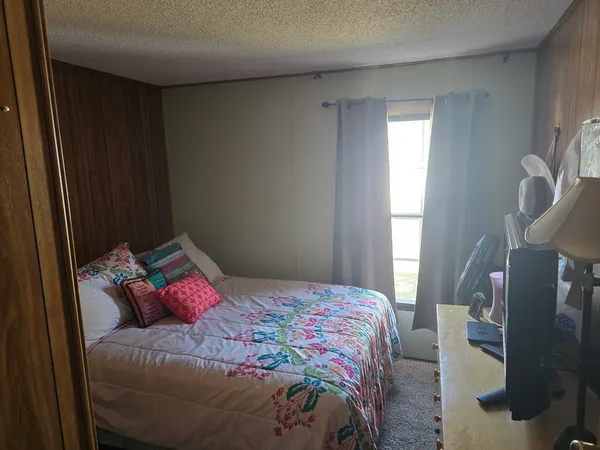 a bedroom with a bed and a window