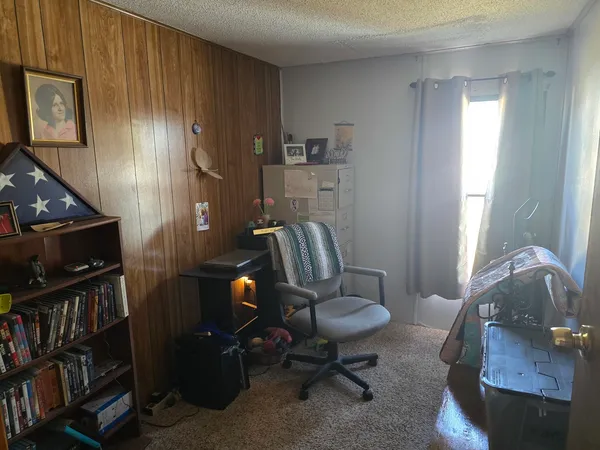 a living room with furniture and a book shelf