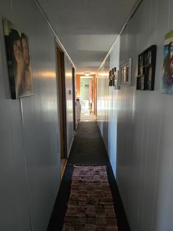 a view of hallway with furniture