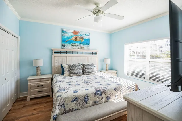 a bedroom with a bed and a painting on the wall