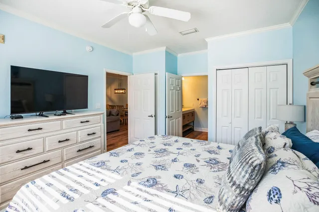 a bedroom with a bed and a flat screen tv in it