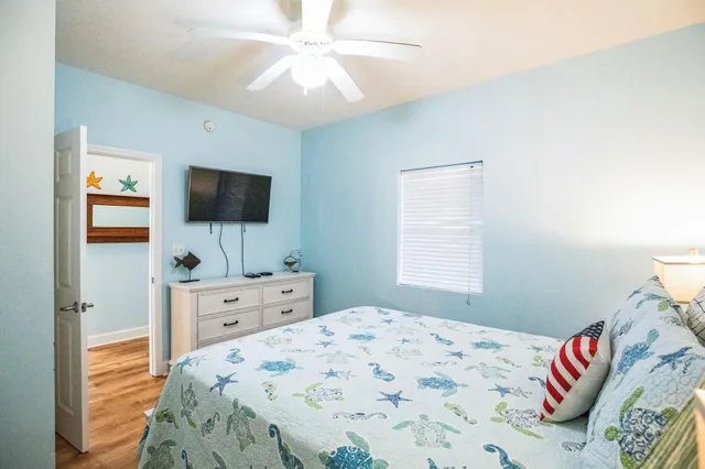 a bedroom with a bed and a flat screen tv