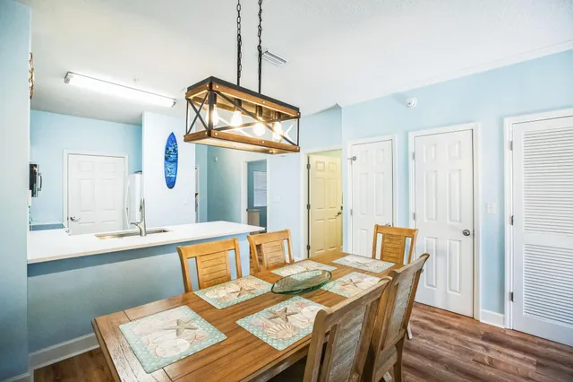 a view of a dining room and a table and chairs in the kitchen
