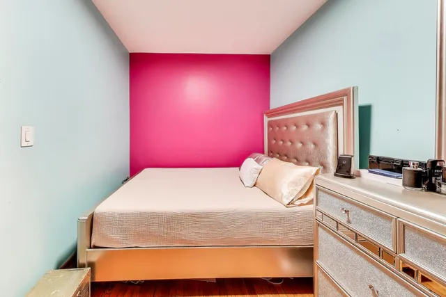 a bedroom with furniture and a wooden floor