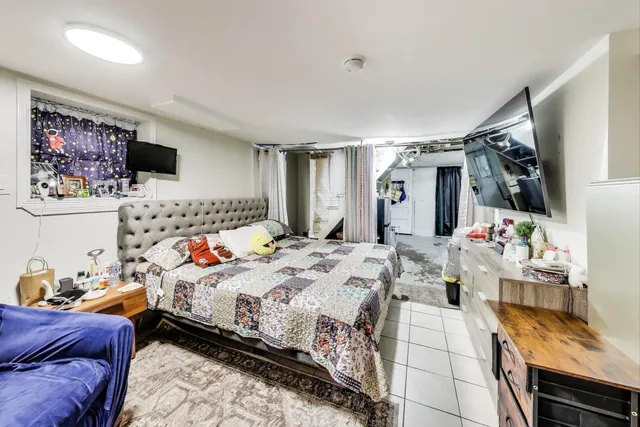 a bedroom with furniture and a large window