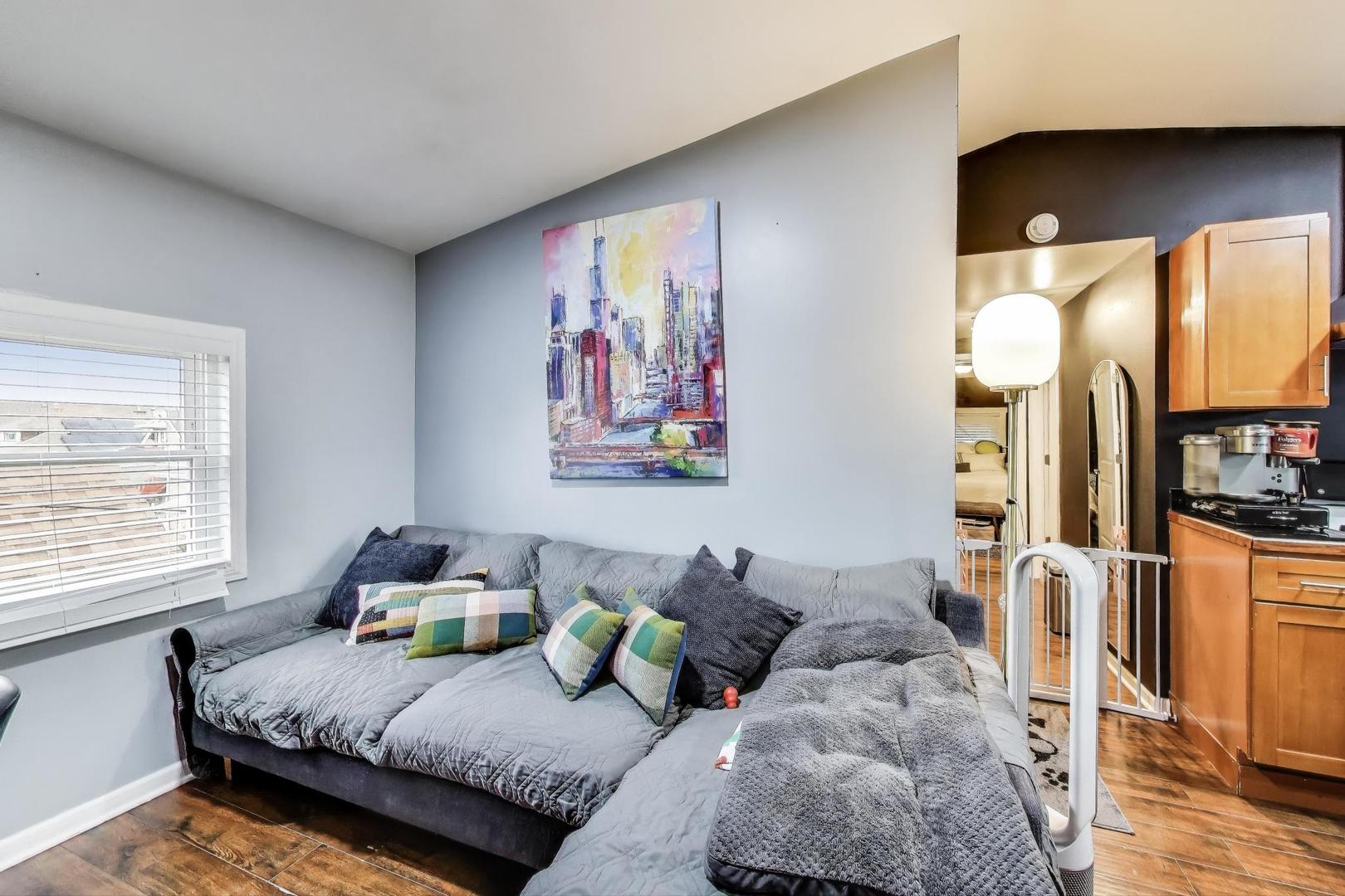 6432 South Kilpatrick Avenue Chicago, IL 60629 - Photo 19 of 36 a bedroom with furniture and a large window