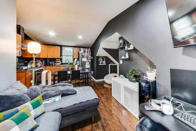 a kitchen with stainless steel appliances a sink a stove cabinets and a window