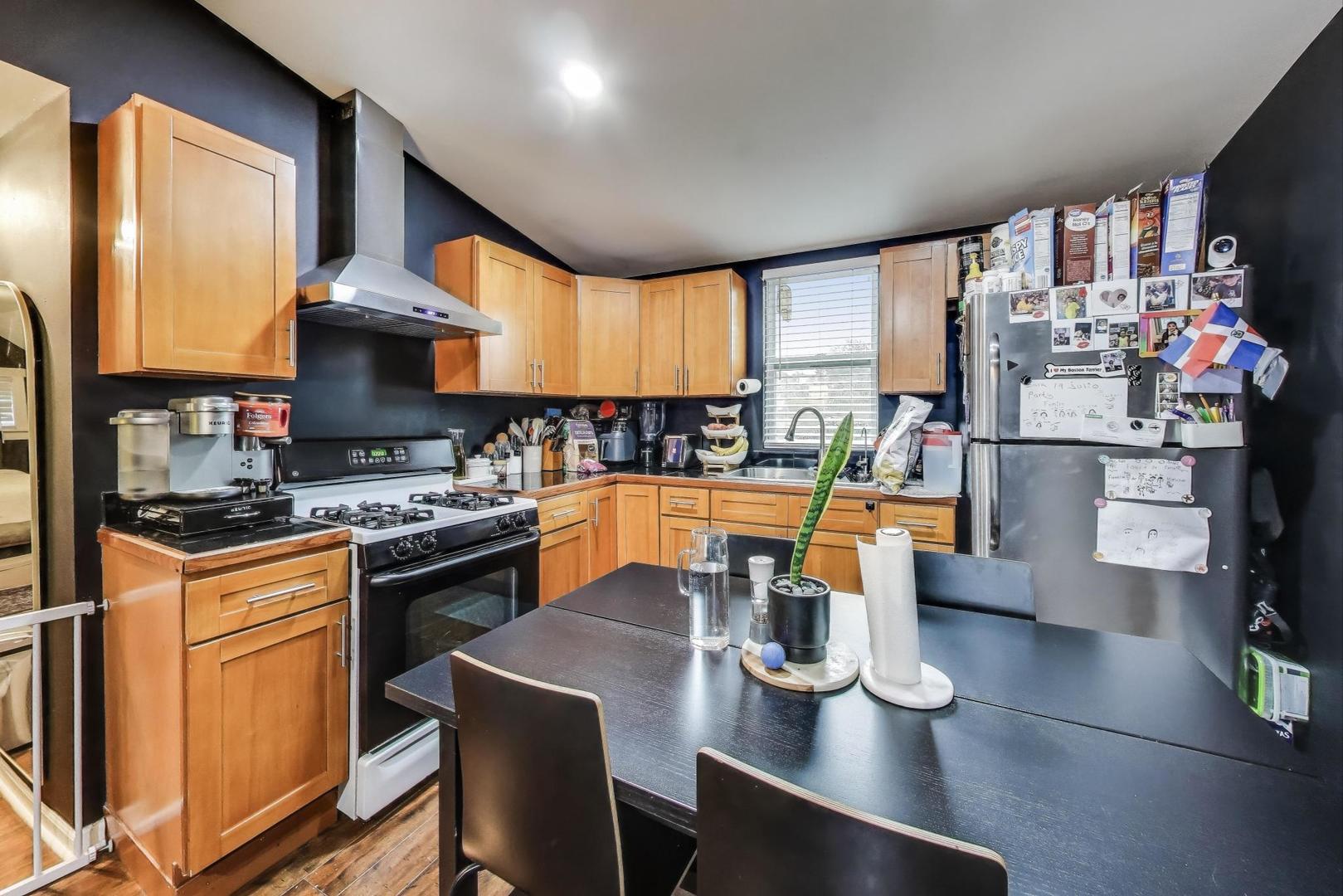 6432 South Kilpatrick Avenue Chicago, IL 60629 - Photo 21 of 36 a kitchen with stainless steel appliances granite countertop a sink stove and refrigerator