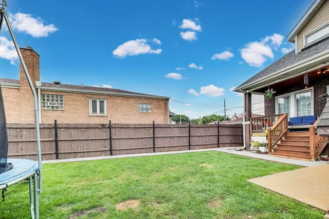 a view of a backyard with a large tree