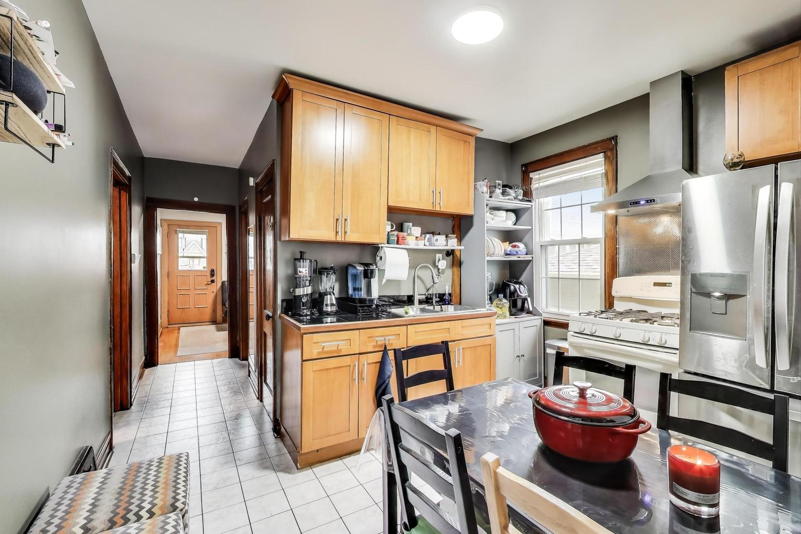 6432 South Kilpatrick Avenue Chicago, IL 60629 - Photo 8 of 36 a kitchen with stainless steel appliances kitchen island granite countertop a refrigerator and a stove top oven