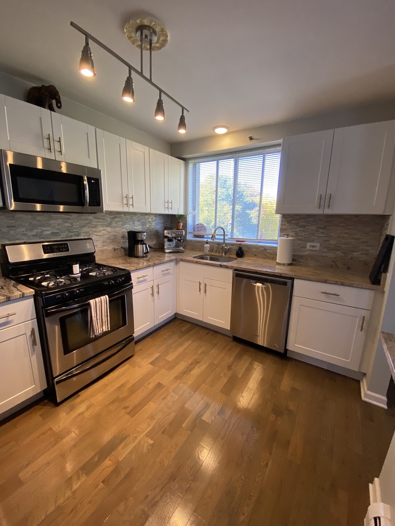 280 North Westgate Road, Unit 331 Mount Prospect, IL 60056 - Photo 8 of 28 a kitchen with stainless steel appliances granite countertop a stove a sink and a microwave