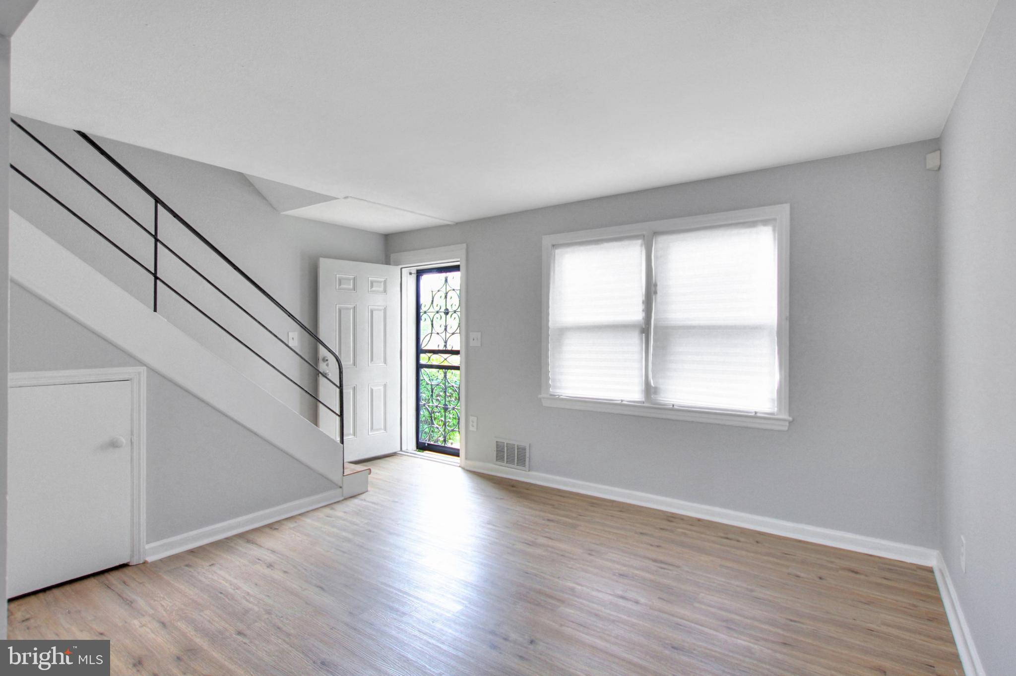 2580 Iverson Street Temple Hills, MD 20748 - Photo 5 of 19 a view of an empty room with wooden floor and a window