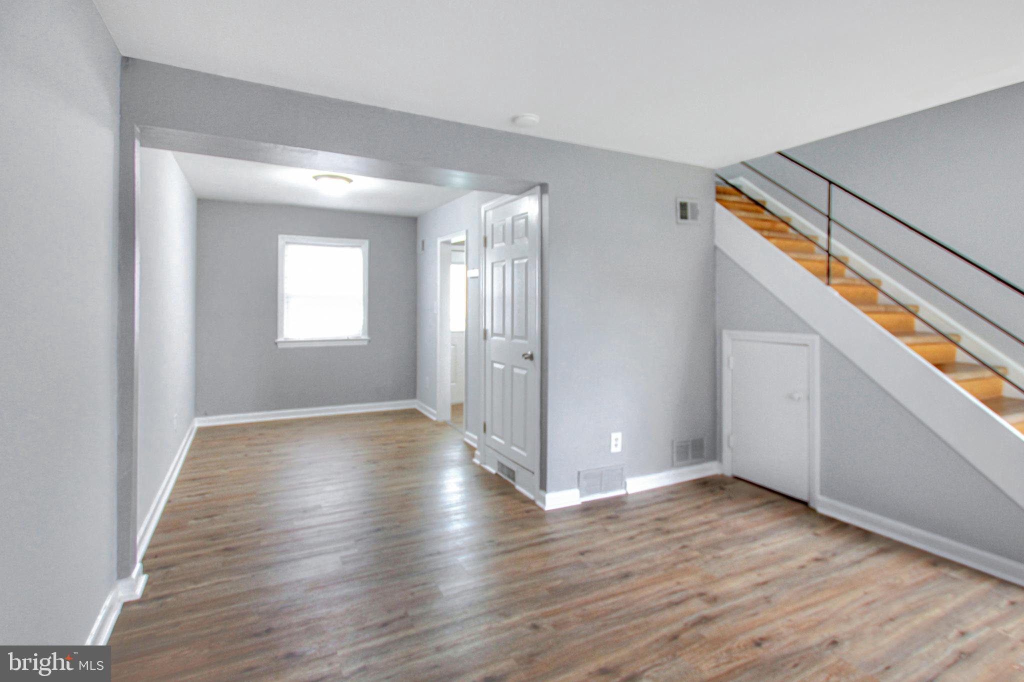 2580 Iverson Street Temple Hills, MD 20748 - Photo 6 of 19 a view of an empty room with wooden floor and a window
