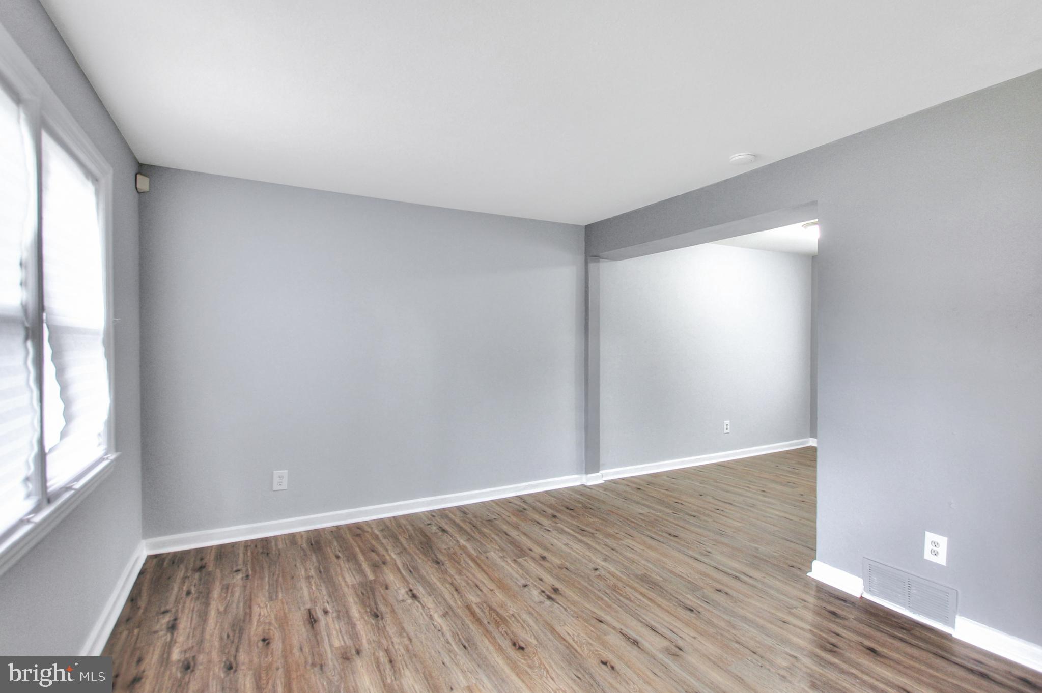 2580 Iverson Street Temple Hills, MD 20748 - Photo 7 of 19 an empty room with wooden floor and windows