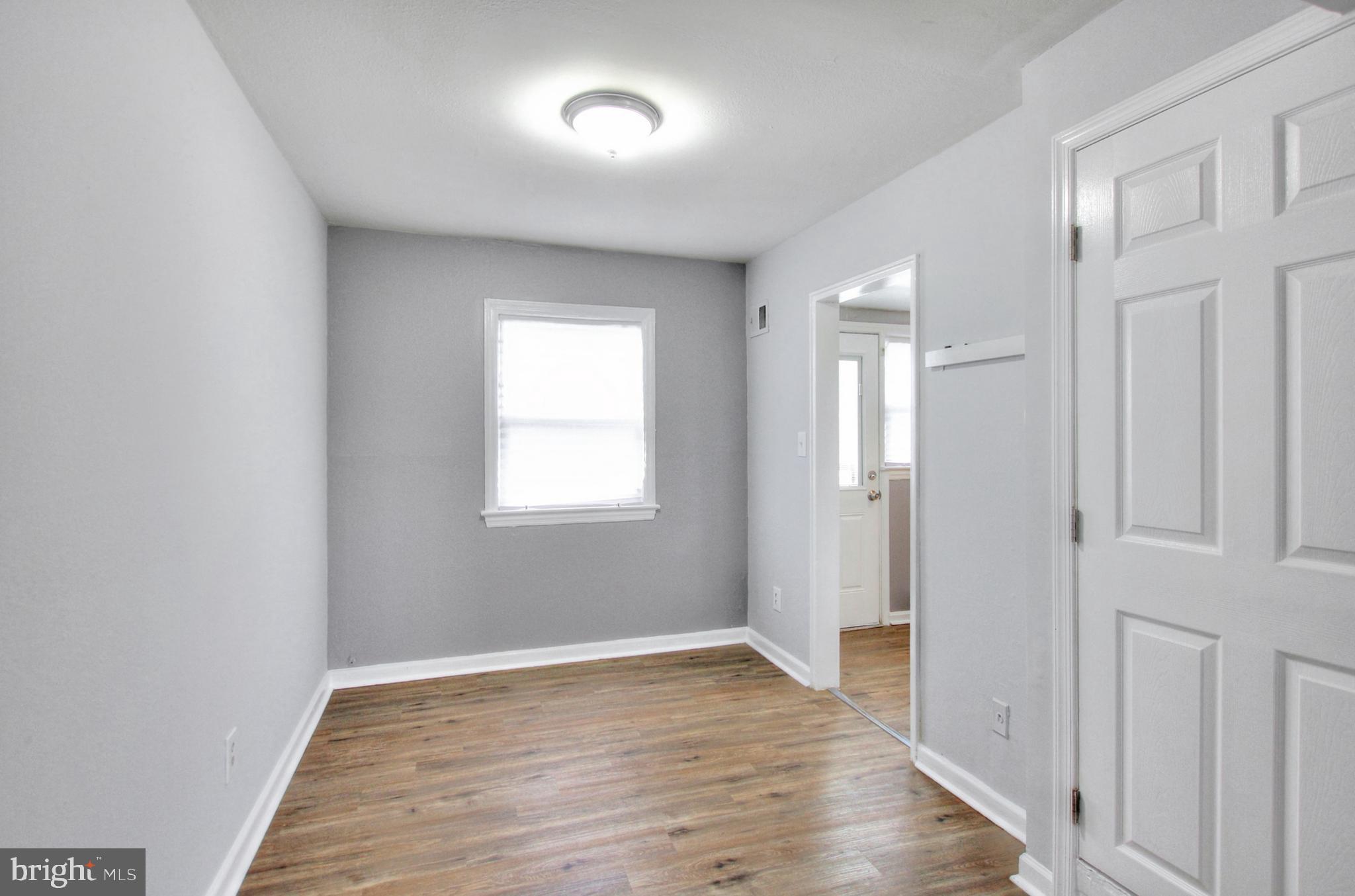 2580 Iverson Street Temple Hills, MD 20748 - Photo 8 of 19 wooden floor in an empty room with a window