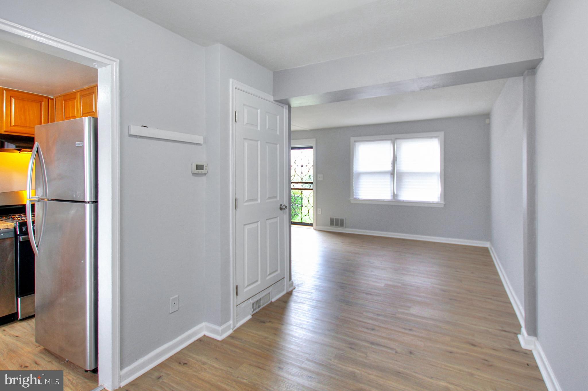 2580 Iverson Street Temple Hills, MD 20748 - Photo 9 of 19 a view of a hallway with wooden floor and a living room