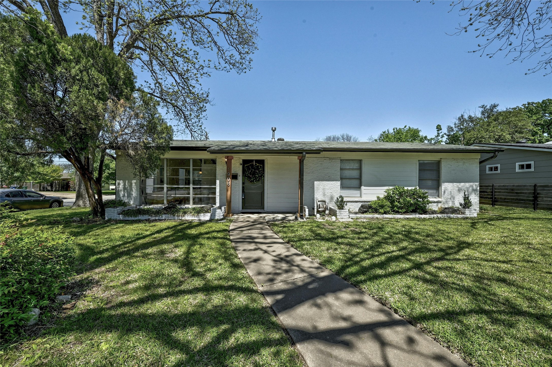 a front view of a house with a garden