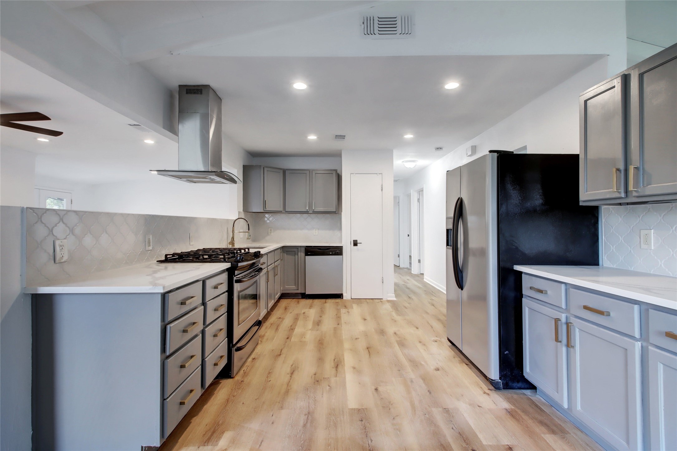 1906 Morrow Street Austin, TX 78757 - Photo 13 of 36 a large kitchen with stainless steel appliances granite countertop a stove a sink and a refrigerator