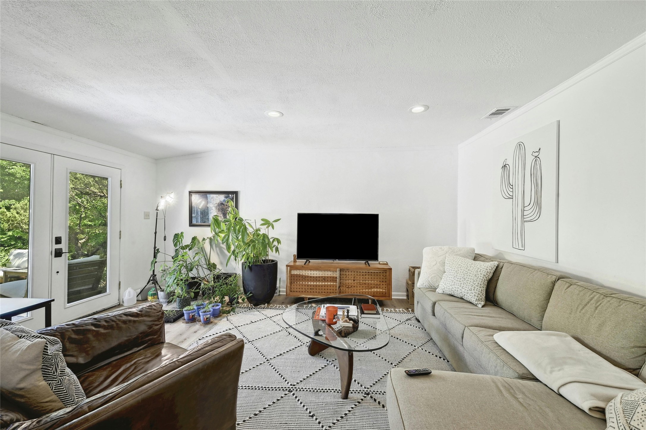 1906 Morrow Street Austin, TX 78757 - Photo 16 of 36 a living room with furniture and a flat screen tv