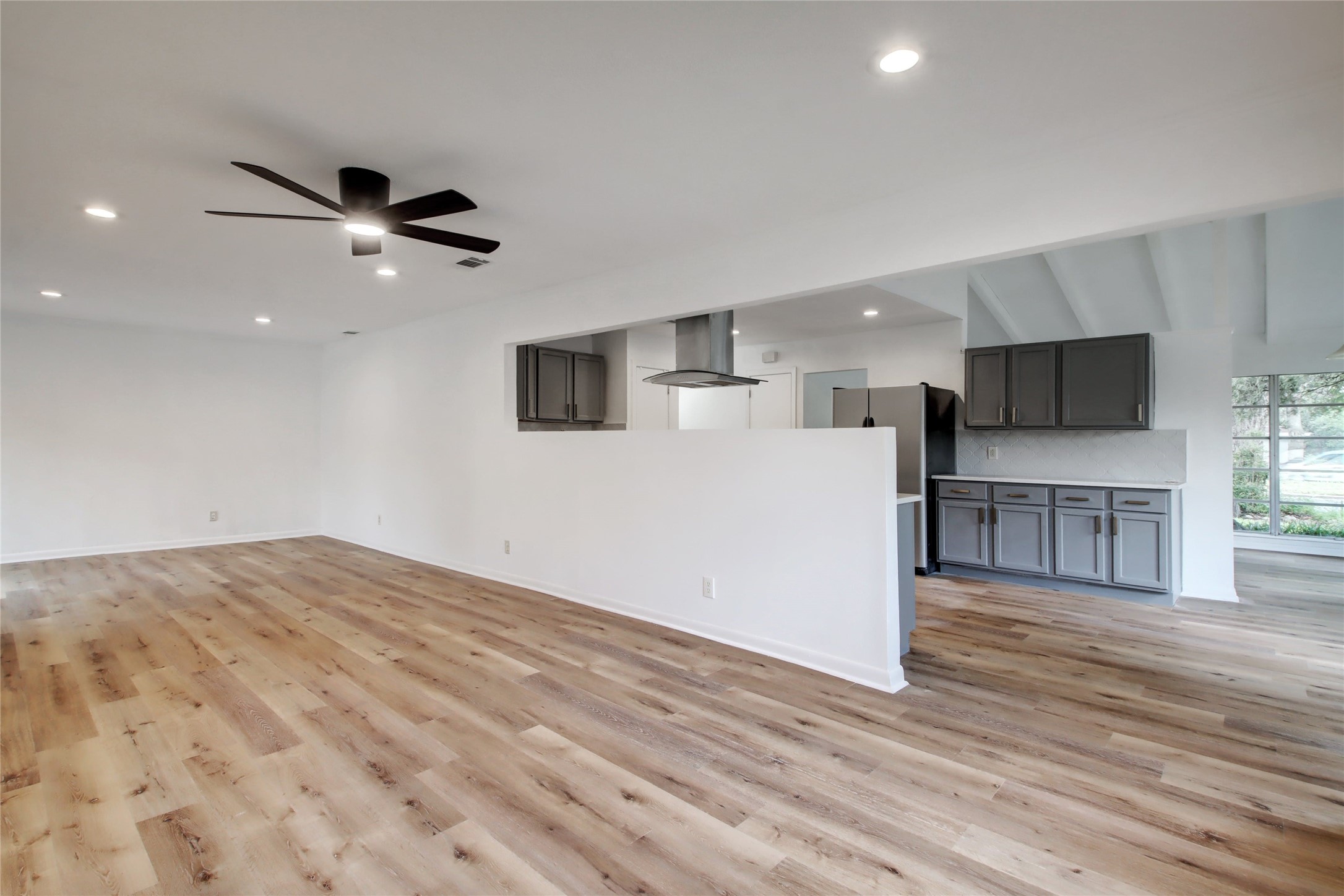 1906 Morrow Street Austin, TX 78757 - Photo 19 of 36 a view of empty room with wooden floor and ceiling fan