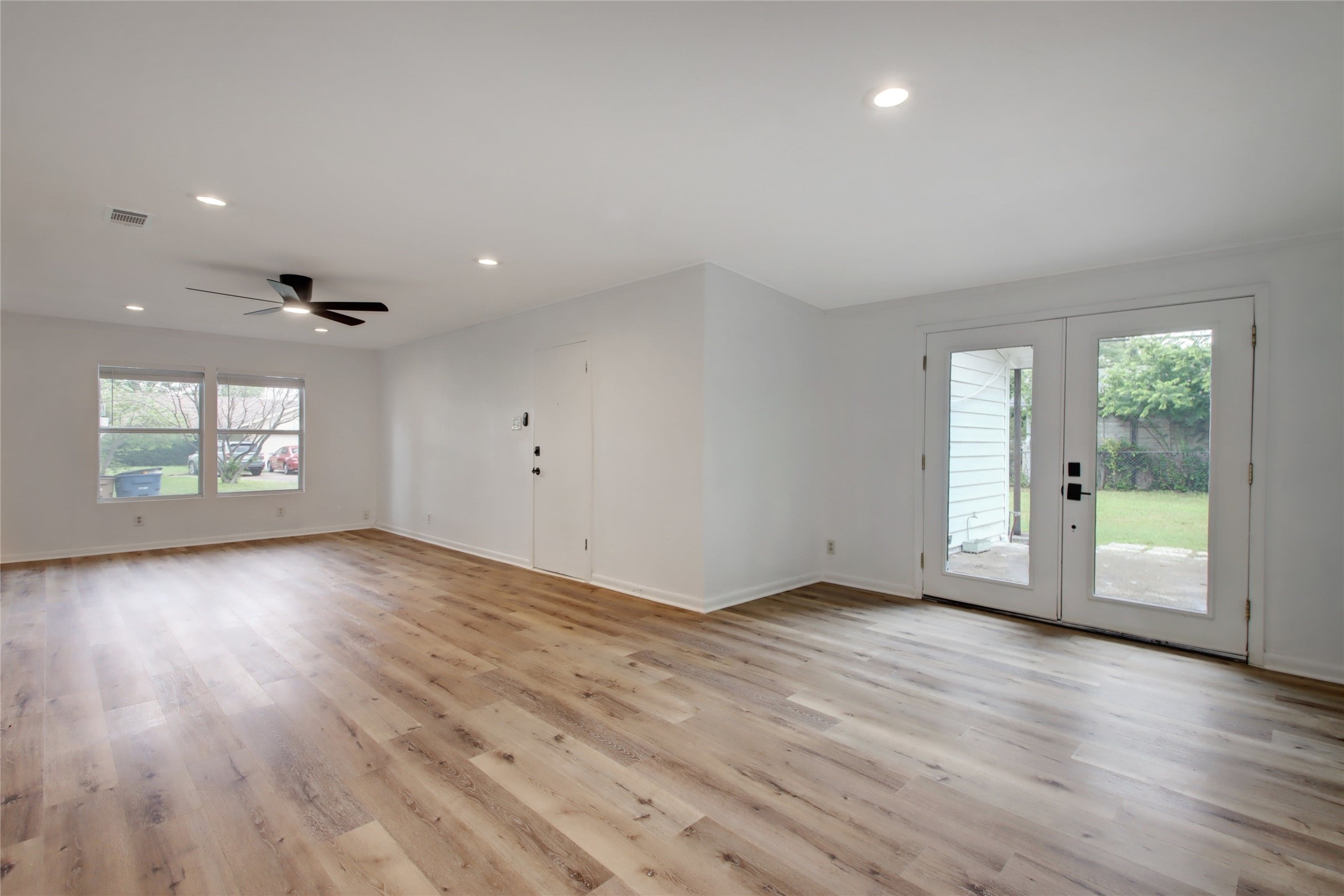 1906 Morrow Street Austin, TX 78757 - Photo 20 of 36 an empty room with wooden floor and windows