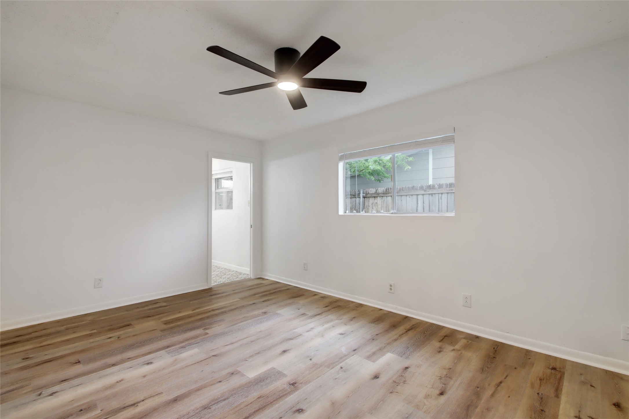 1906 Morrow Street Austin, TX 78757 - Photo 21 of 36 a view of empty room with wooden floor and fan