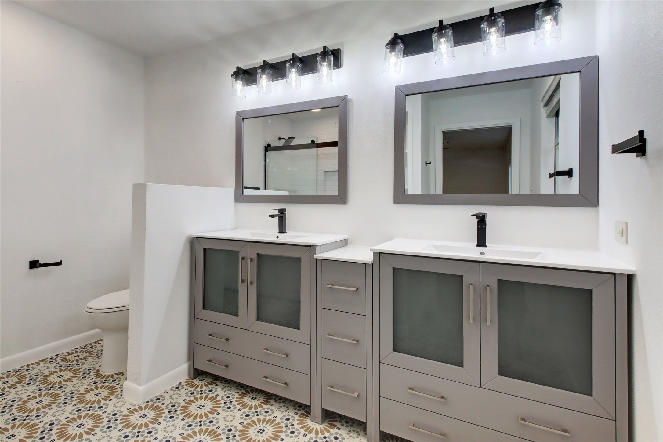 1906 Morrow Street Austin, TX 78757 - Photo 23 of 36 a bathroom with a toilet sink and mirror