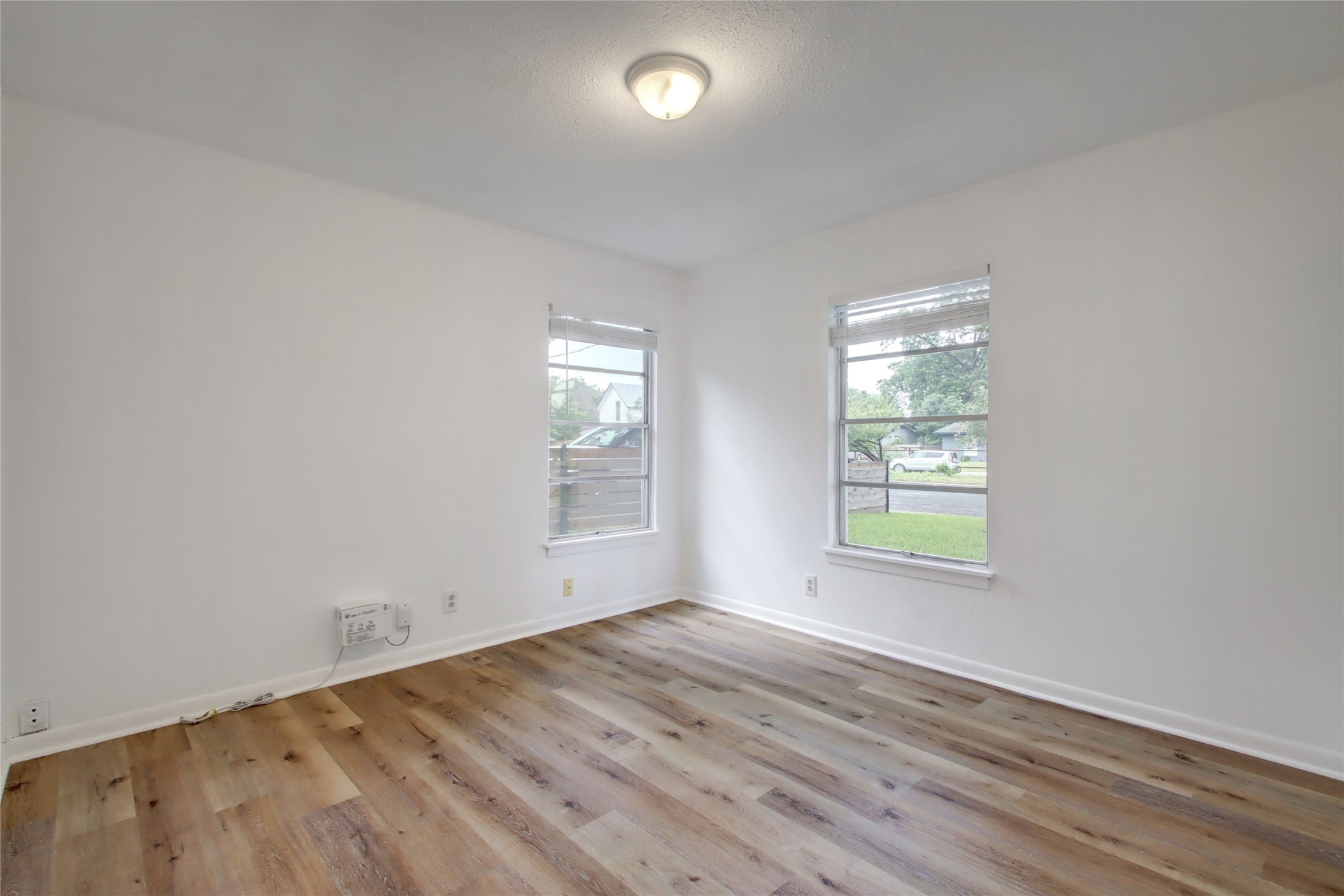 1906 Morrow Street Austin, TX 78757 - Photo 24 of 36 an empty room with wooden floor and windows