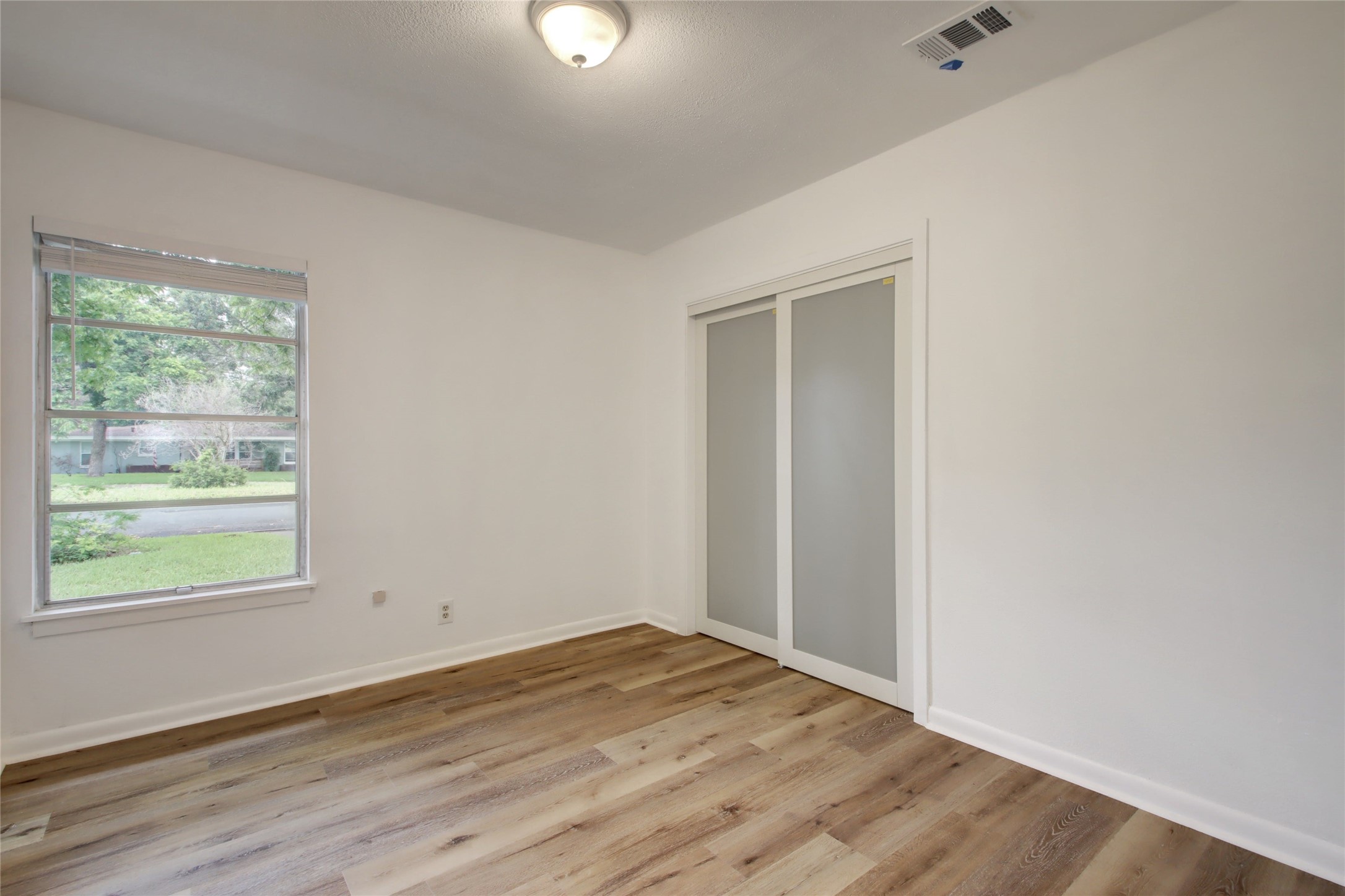 1906 Morrow Street Austin, TX 78757 - Photo 25 of 36 an empty room with wooden floor and windows