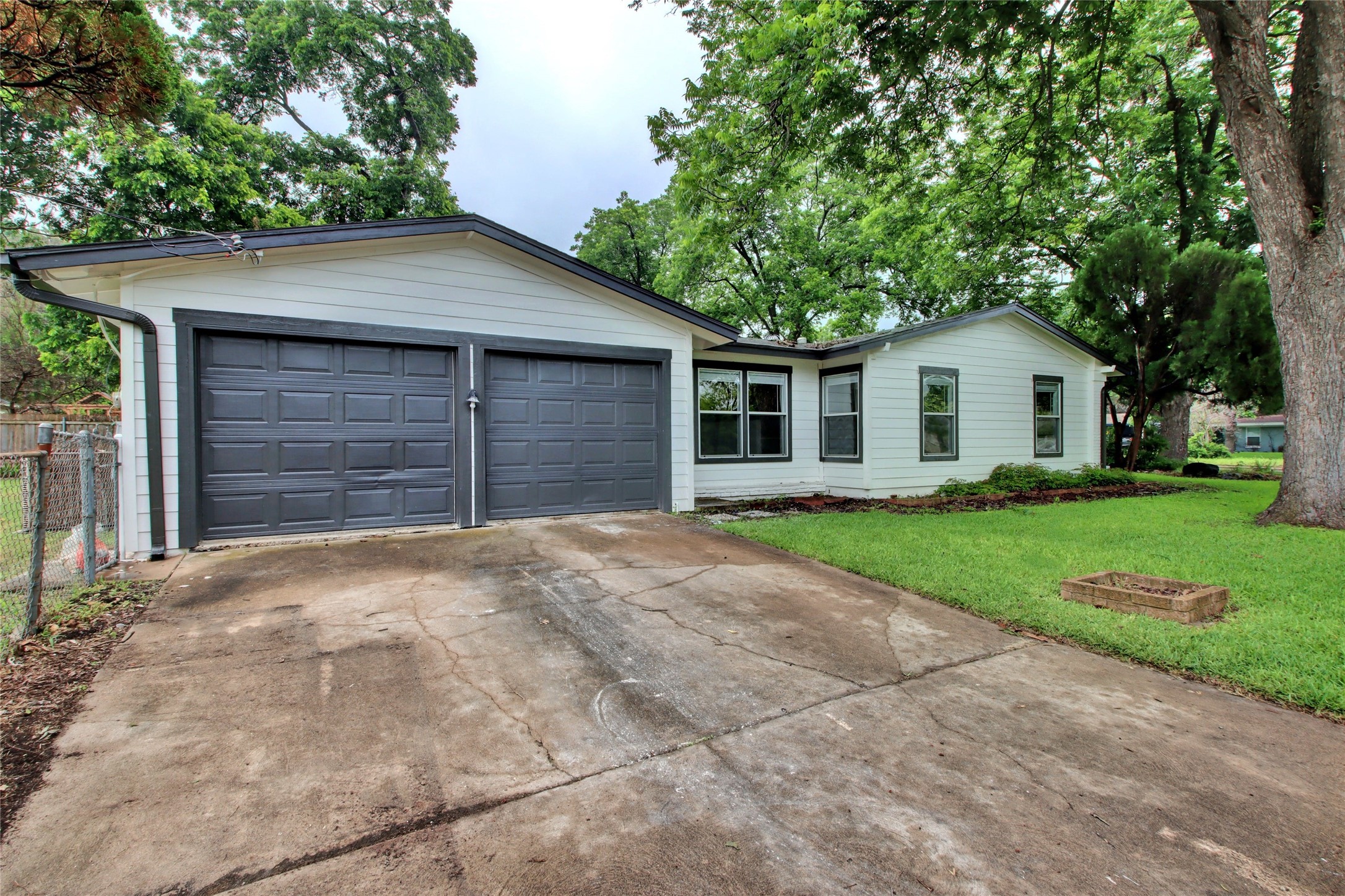 1906 Morrow Street Austin, TX 78757 - Photo 32 of 36 a front view of a house with a yard and garage