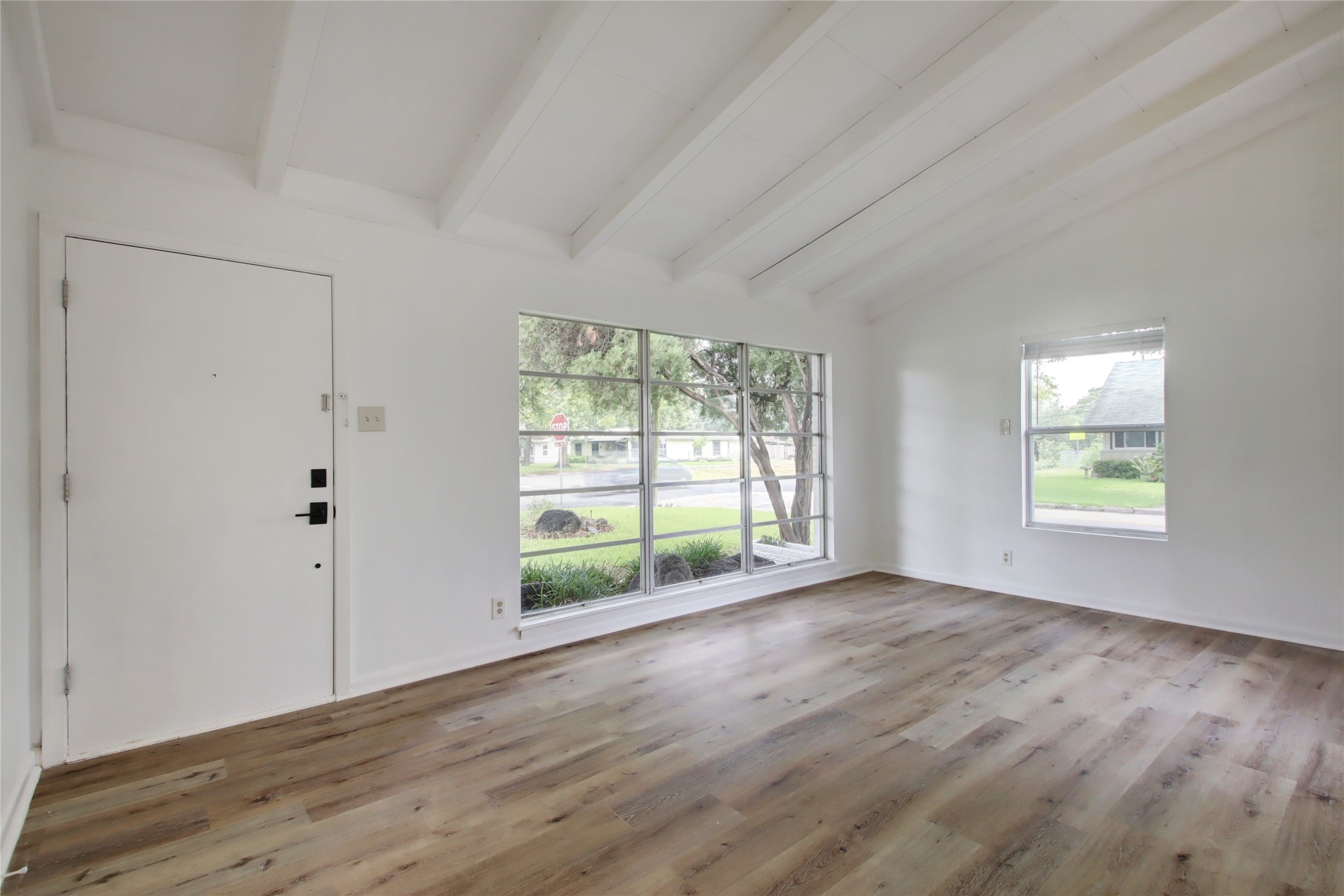 1906 Morrow Street Austin, TX 78757 - Photo 9 of 36 an empty room with wooden floor and windows
